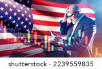 Small photo of American investor. Man with tablet grabs his head. Businessman near American flag. Businessman from USA went bankrupt. Losses in US financial market. Bankruptcy company in United States of America