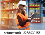Small photo of Storekeeper girl. Woman with clipboard stands in warehouse building. Bonded warehouse manager conducts audit. Woman in orange vest and hardhat in warehouse hangar. Storage company specialist