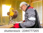 Small photo of Man joiner. Stationary circular saw. Carpenter saws wooden board. Joiner at work. Man uses circular saw. Equipment for woodworking. Joiner in gray uniform. Construction worker sawing parquet