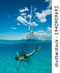 Small photo of Diving girl and boat at anchor in the bay of Pori on the northeastern coast of the Greek island of Pano Koufonisia in the Small Cyclades