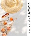 Small photo of Vintage inspired background with straw hat, female sunglasses and shopper bag with peaches on white towel. Minimalist summer vacation creative still life ​for fashion blog, web, social media, stories.