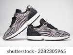 Small photo of kent, uk 01.01.2023 RARE ADIDAS torsion zx FLUX DECON zebra print basketball and sport trainers , stylish retro football street fashion. famous 3 stripes torsion trademark. famous three stripes brand