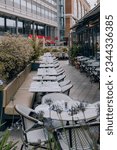 Small photo of London, UK - July 06, 2023: Outdoor tables of Cote Brasserie restaurant in St Katharine Docks, a former dock and now a mixed-used district and London's only marina in Central London.