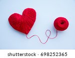 Colorful yarn ball isolated on white background. Space for text. Red heart like a symbol of love. Hobby concept
