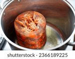 Small photo of Frozen crayfish are thawed in a saucepan.