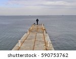 Lone Fisherman Standing On The...