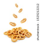 Small photo of Pretzel with many small cookies scattered and falling from above on a white background. Traditional food for Oktoberfest - salt pretzels appetizer on a white background. German Pretzel (Bretzel), Okto