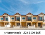 The row of just finished new yellow townhouses, Front View of New Residential house, the architectural design of the exterior with blue sky and apace,The concept for Sale, Rent,Housing,and Real Estate