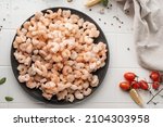 Small photo of Thawed peeled shrimp, seafood, delicacy. on a white background, in a dish. beautiful product presentation