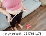 Small photo of Obese Woman with fat belly in dieting concept. Overweight woman touching his fat belly and want to lose weight. Fat woman her waist with a centimeter. Shape up healthy