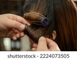 Small photo of the process of getting a woman's hair permed