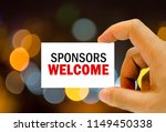 sponsors welcome written on business card man hand holding