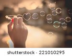  My Heart Bubbles at the sky, sunset,Love in the summer sun with bubble blower,romantic inflating colorful soap bubbles in park