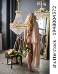 Small photo of Person in the bedroom with flowers. Negligee