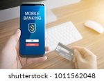 a man holding mobile smart... | Shutterstock . vector #1011562048