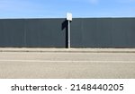 Black wooden panels fence and a ...