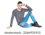 Small photo of young man sit on floor with hand on head and knee bend for his elbow whole look at camera with serious and earnest mien
