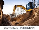 Small photo of Excavator digging a hole into the ground
