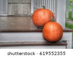 Two Pumpkins On Wooden Porch...