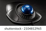 Small photo of Trackball Computer Mouse on a blue background. Control Device with Scroll Wheel