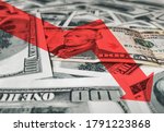 Small photo of The bright red arrow icon on a background of money. The concept of changing course of US dollar on the market. Devaluation, collapse, stagnation of the economy owing to Quarantine coronavirus covid-19