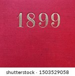 The year 1899 printed in gold on the red cloth binding of a yearbook published that year
