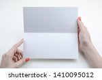 a woman holding white booklet.... | Shutterstock . vector #1410095012