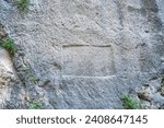 Small photo of Samandag, Antakya, Turkey- December 29, 2023: the reliefs of Vespasianus Titus Tunnel, which is an ancient water tunnel built for the city of Seleucia Pieria, Antakya, Turkey
