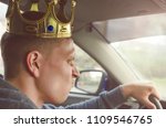 Small photo of Annoyed selfish driver with golden crown above his head driving a car. Disdainful and boorish attitude on the road concept.