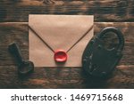 Small photo of Top secret documents in envelope, rusty padlock and a key on a wooden table flat lay background. Confidential information concept.