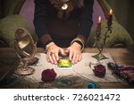 Tarot cards on wooden table and fortune teller hands. Reading future.