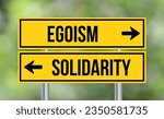 Small photo of Egoism or solidarity road sign on blur background