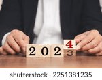 Business plan and countdown to 2024. Flipping of 2023 to 2024 on wooden cubes for preparation of new year change and starting new business target strategy concept