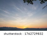 Heaven at early morning with copy space. Smooth orange blue gradient of dawn sky.Sunset, sunrise backdrop.Predawn clear sky with orange horizon and blue atmosphere.  Background of beginning of day. 