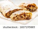 homemade apfelstrudel, Apple strudel with raisins and mint on light background. view from above, Food recipe background, austrian germany food.