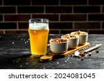 Bowl Of Nuts And Beer On Wooden ...