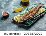 Baked trout fish, Grilled trout barbeque with lemon, Healthy eating concept. banner, menu, recipe place for text, top view,