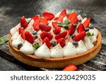 Delicious homemade white cream pie with mint on a wooden board, on a dark background, banner, menu, recipe place for text, top view.