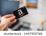 Small photo of Washington, D.C. / USA - July 10, 2019: A hand holds a $50 Amazon gift card, a which allows the recipient to purchase items from the Amazon.com website.
