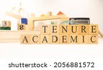 Small photo of The word Academic tenure was created from wooden cubes. Close-up.