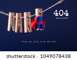 Error 404 page not found web page. Toy clothespin peg superhero on clothesline, blue background. Trust me help is on the way text message.