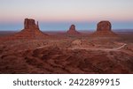 Small photo of The Mittens in Monument Valley, iconic sandstone buttes, stand tall against the vivid desert sky. Their majestic silhouettes, carved by wind and time, epitomize the timeless beauty of the Southwest.