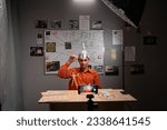 Small photo of Young conspiracy theorist in foil hat vlogger or blogger recording conspiracy tutorial to share on website or social media. Crazy business online influencer on social media concept.