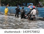 Small photo of Mumbai / India 01 July 2019 People wade through water-logged streets after Mumbai continues to be lashed by heavy rain in Maharashtra India