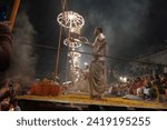 Small photo of Varanasi , India - 8 December 2023, Main famous scene of Aarti of Banaras Ghat priest worshiping with oil lamp and incense sticks at dasaswamedh ghat in Varanasi Uttar Pradesh India