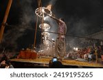 Small photo of Varanasi , India - 8 December 2023, Main famous scene of Aarti of Banaras Ghat priest worshiping with oil lamp and incense sticks at dasaswamedh ghat in Varanasi Uttar Pradesh India