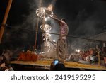 Small photo of Varanasi , India - 8 December 2023, Main famous scene of Aarti of Banaras Ghat priest worshiping with oil lamp and incense sticks at dasaswamedh ghat in Varanasi Uttar Pradesh India