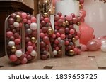 huge volumetric inscription one for celebration in a restaurant with small balloons