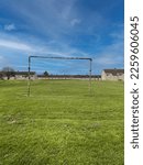 Small photo of Unlevel football (soccer) goal on public grass area in a Scottish 1960s housing estate