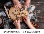Christmas bakery. Friends making gingerbread, cutting cookies of gingerbread dough, view from above. Festive food, cooking process, family culinary, Christmas and New Year traditions concept